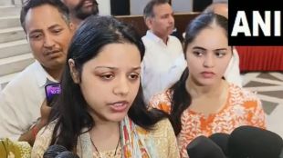 Himanshi Narwal, widow of Navy officer Vinay Narwal, salutes her husband's coffin during a wreath-laying ceremony at Delhi Airport, urging national unity and peace after the Pahalgam terror attack.
