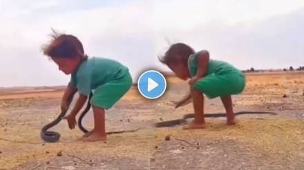 Small boy playing with snake