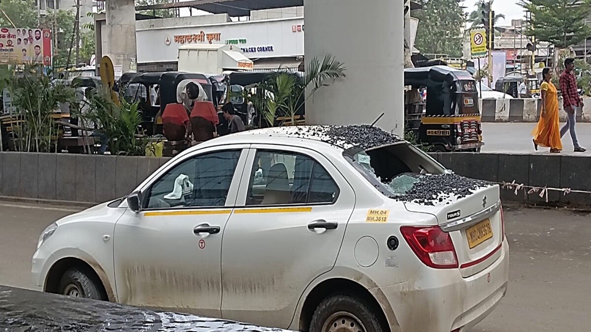 gravel asphalt falls on vehicle, Vehicle damaged Palava Chowk,
